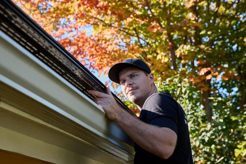 Installer with gutter equipment on site